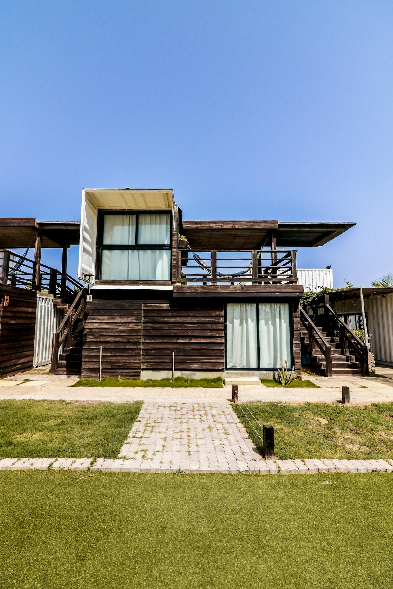 Contemporary wooden villa exterior with grassy surroundings in Adicora, Venezuela.