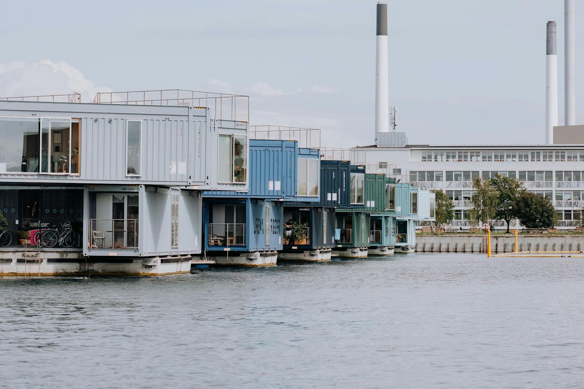 Innovative container homes on water, showcasing modern urban living in Copenhagen's harbor.